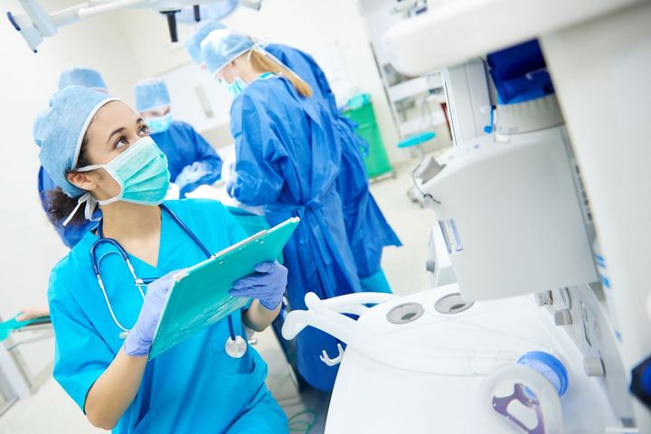 A nurse in the operating room checks her patient's chart.