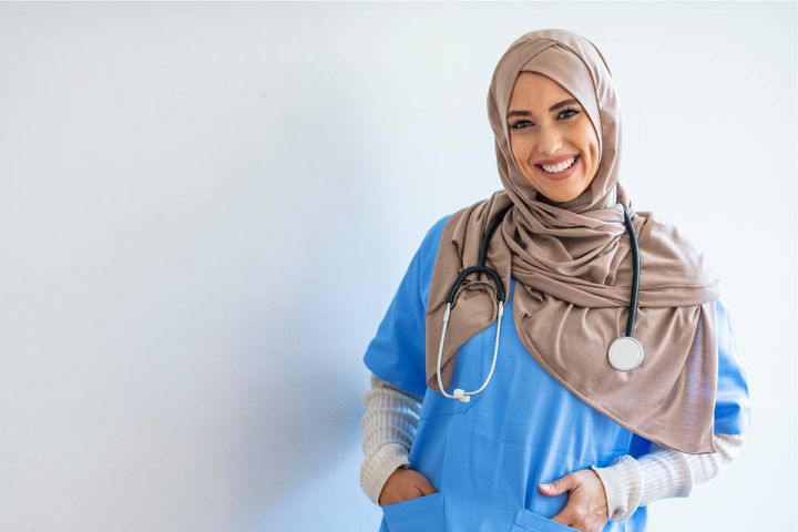 A nurse poses for a photo while discussing the perks of being a nurse.