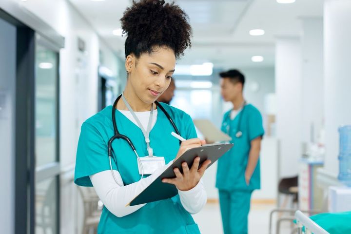 A triage nurse does paperwork.