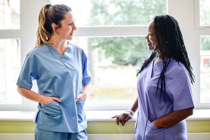 Nurses at a Utah hospital, having a discussion in the hallway.