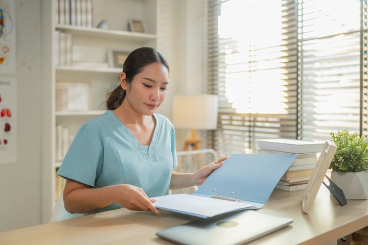 Florida CNA providing certification to hiring manager in an office
