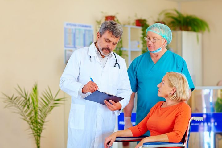A doctor and a nurse discharge a patient from a hospital.