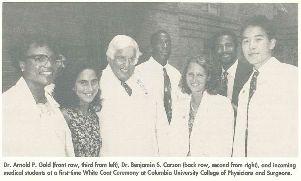 Photo of Dr. Arthur P. Gold, Dr. Benjamin S. Carson, and incoming medical students in white coats dated 1993.
