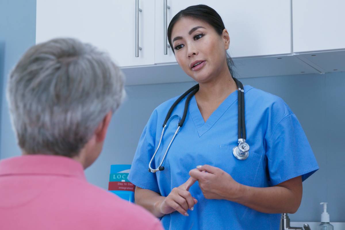 Demonstration of a nurse as an advocate for patient dignity as she speaks to a patient.