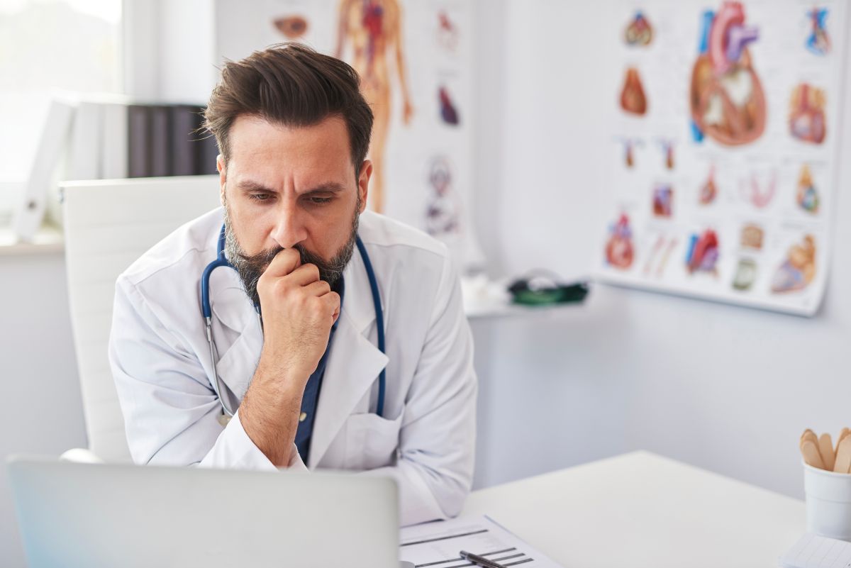 A physician looks at a suspicious medical file.