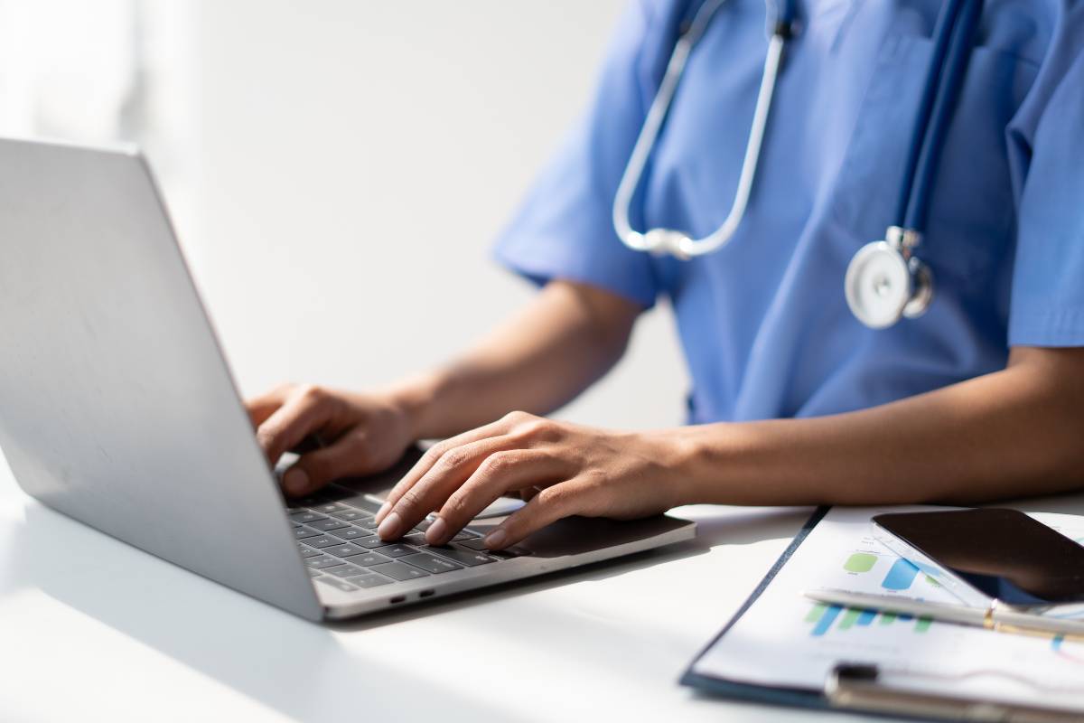 A nurse fills in anonymous nurse income reports on her computer.