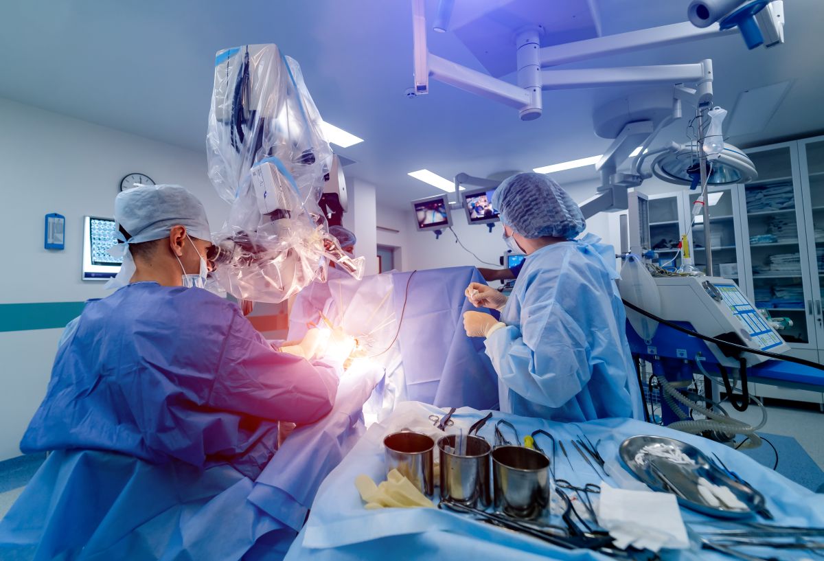 Physicians and nurses oversee an artificial intelligence-enable robotic surgical procedure.