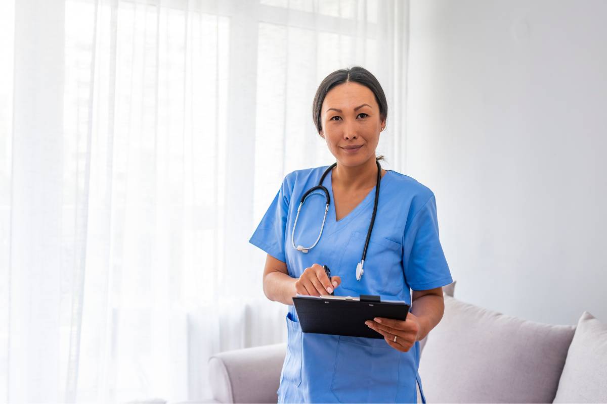 A nurse with BC-ADM certification holds a clipboard with information about her recertification application.