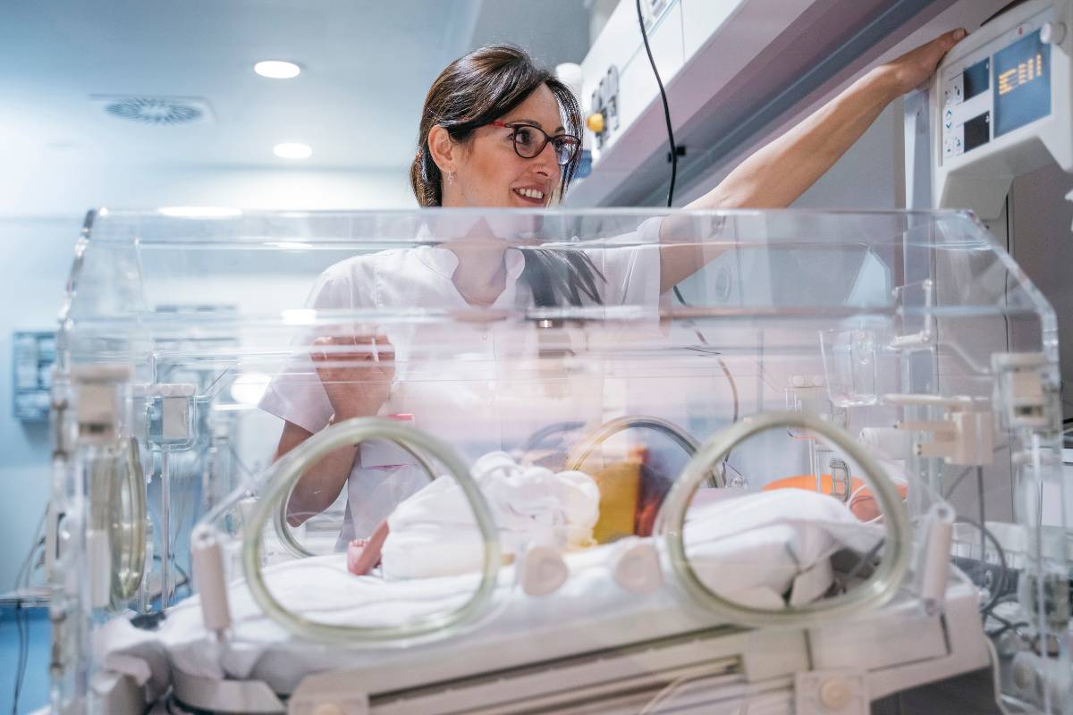 A nurse with C-ELBW certification checks a baby in the neonatal ICU.