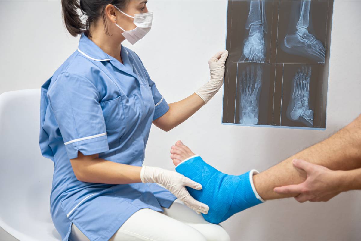 A nurse with CFCN certification performs a foot assessment.