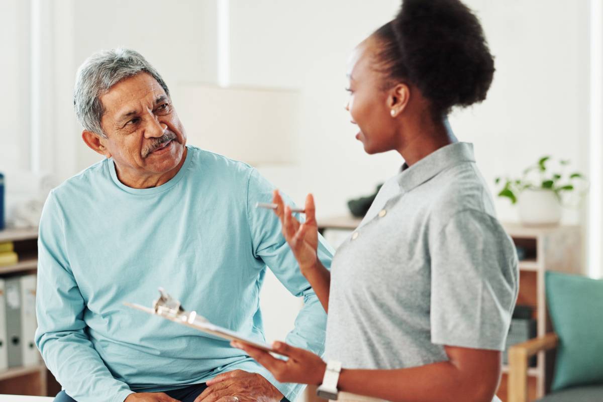 A nurse with CHPN certification speaks with a patient.