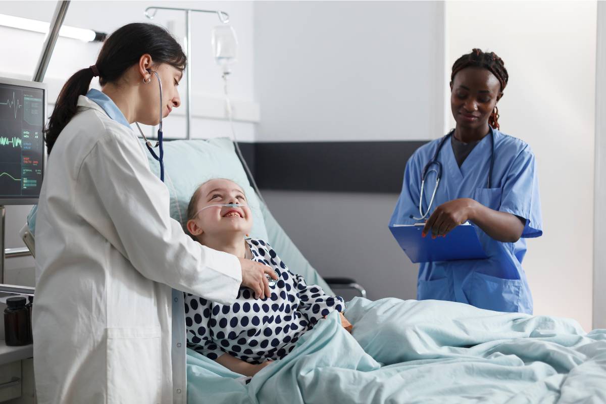 A nurse uses cluster care while caring for a patient in a hospital room.