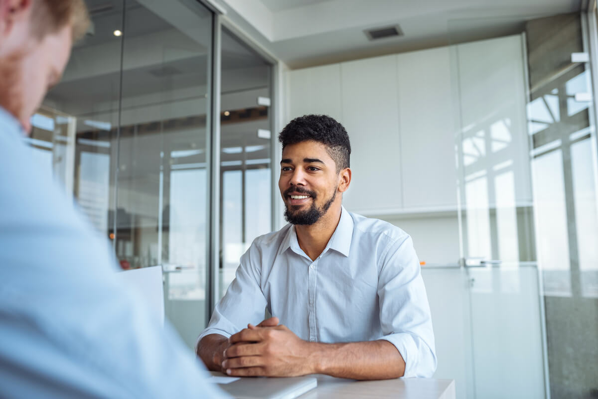 Young African American male answering CNA interview questions for a job.