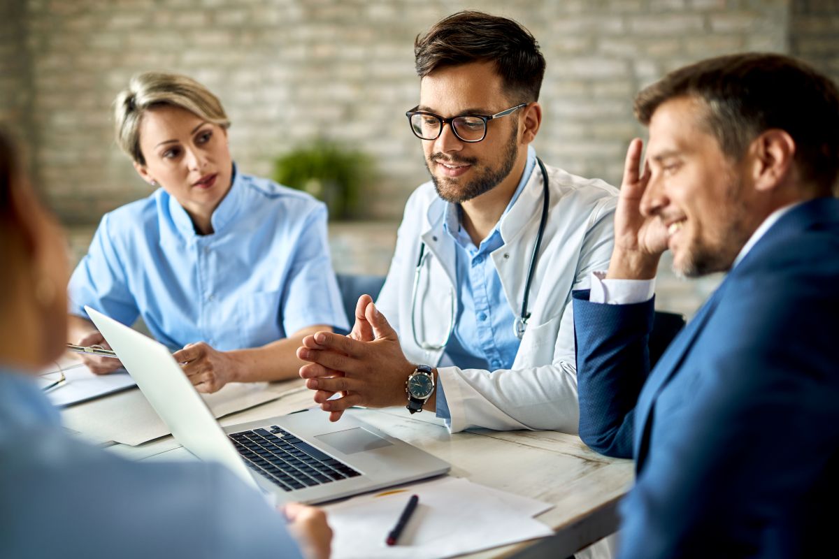 Four healthcare facility managers discuss a report generated by their compliance monitoring tools.