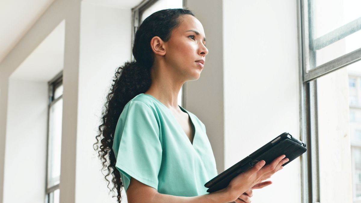 A correctional nurse checks a patient's chart before an appointment.