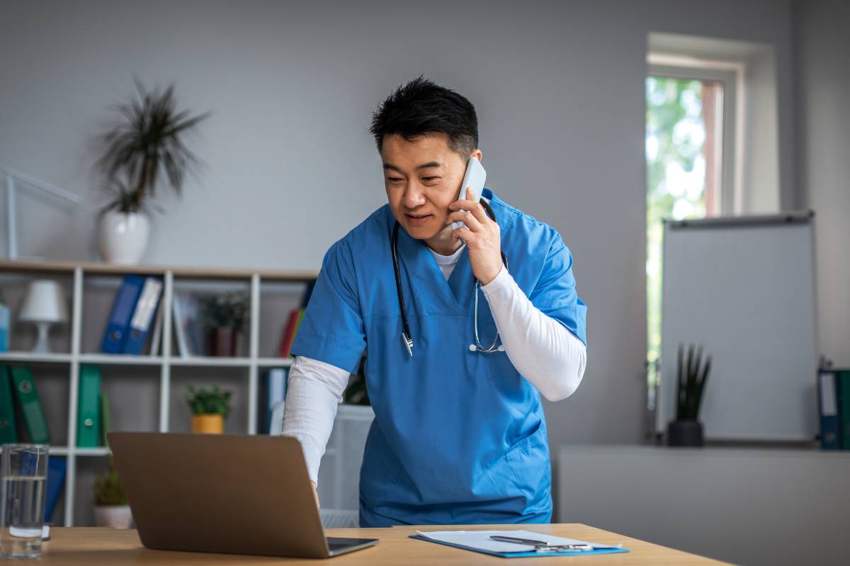 A nurse manager with CPHQ certification works on quality improvement measures in an office.