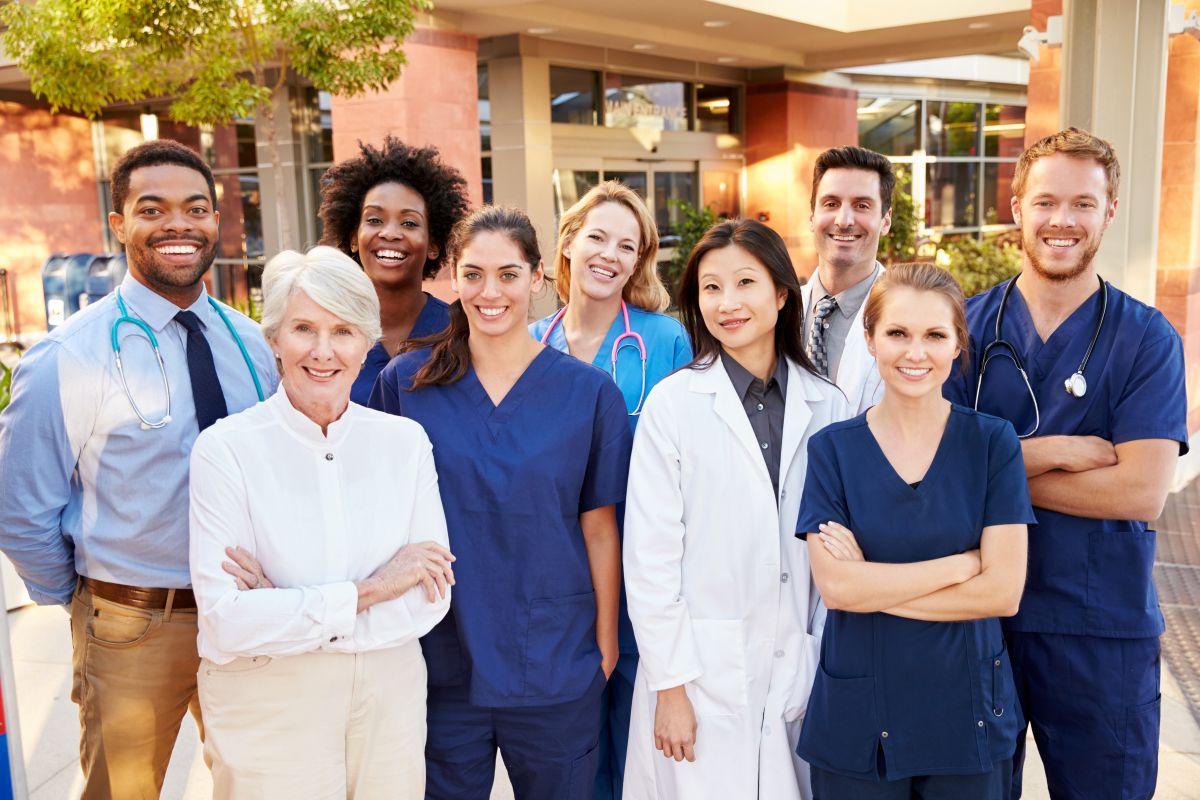 A hospital's staff stands outside of the facility.