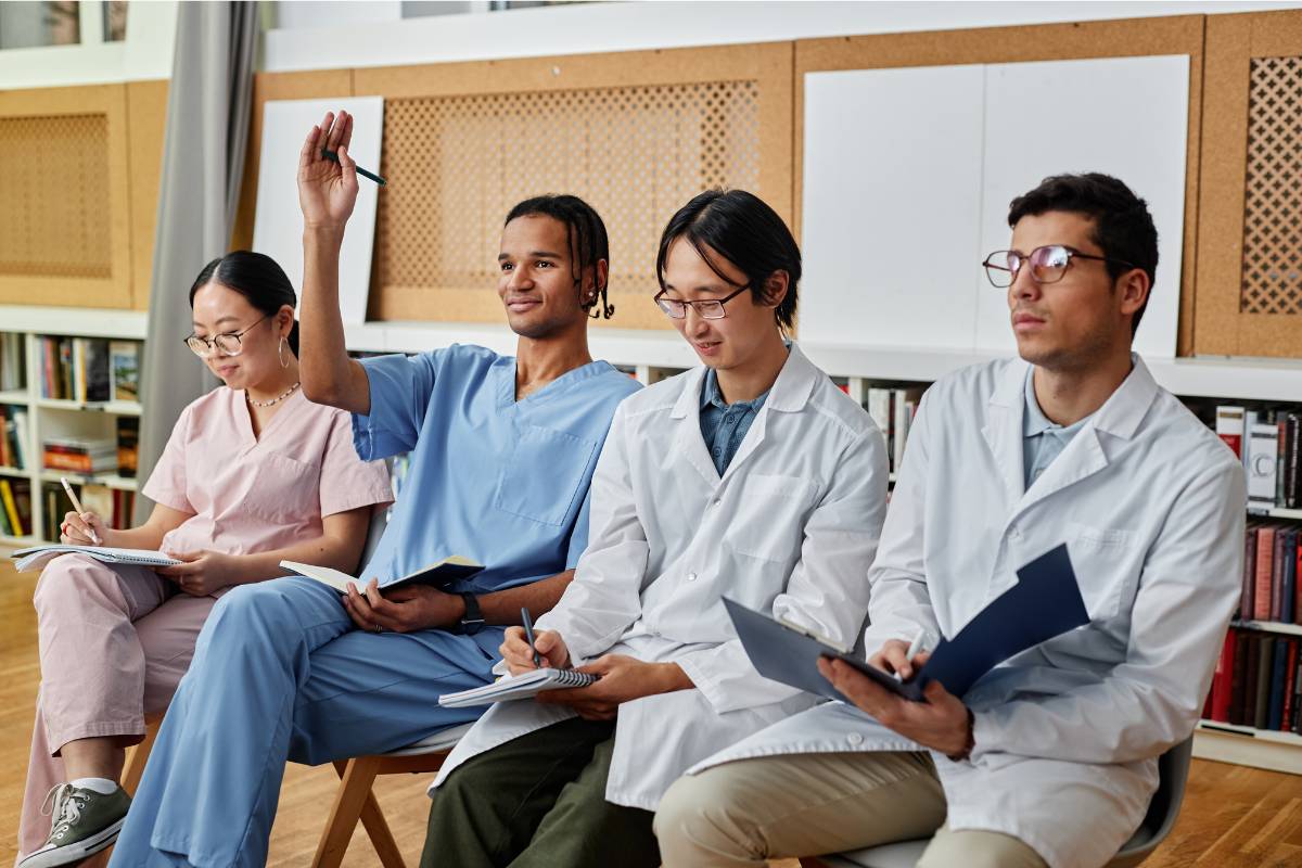 A group of nurses sit in class to earn a DNP degree.