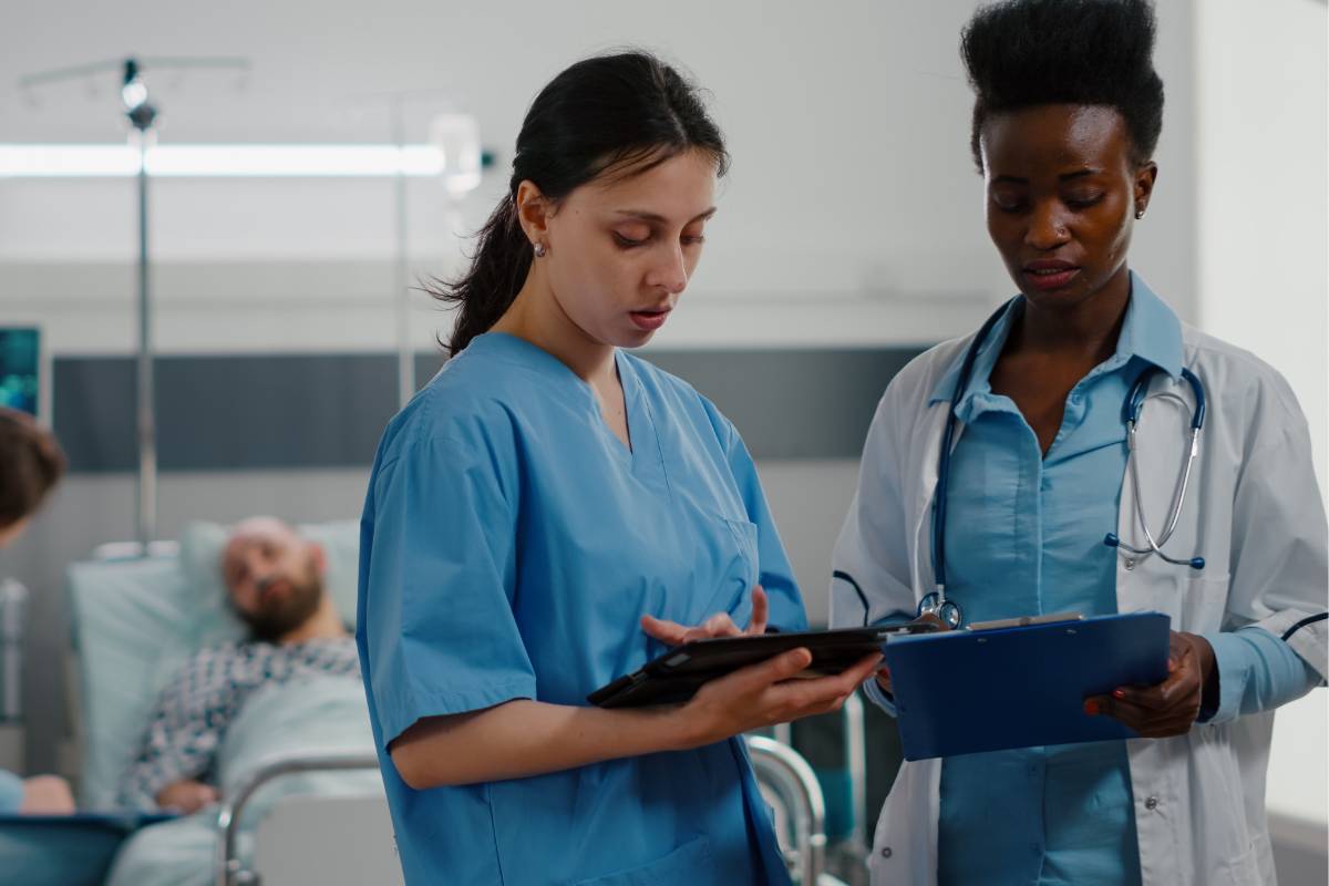 Two healthcare professionals discuss doctor or nurse responsibilities.