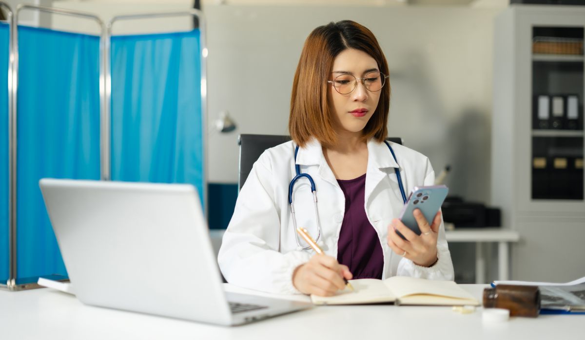 A physician checks her EHR system.
