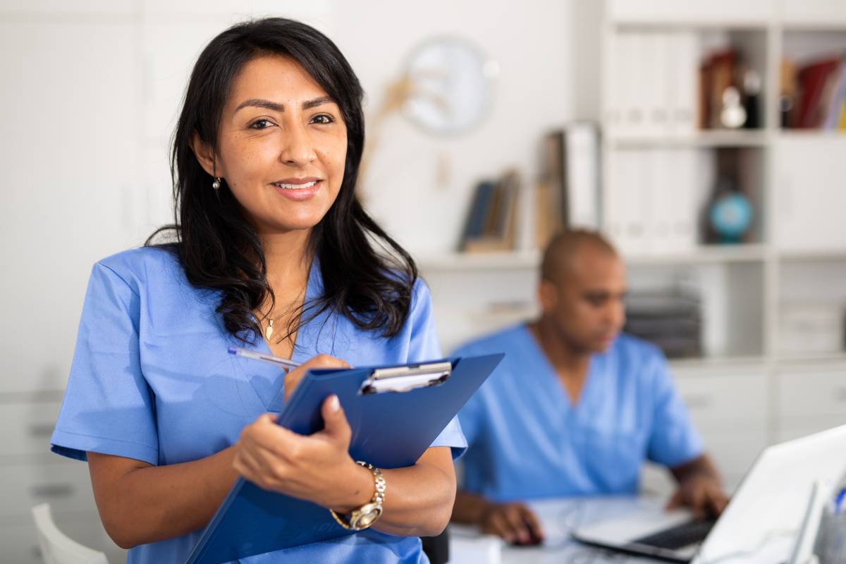 A nurse works on her experienced nurse resume while preparing for job applications.