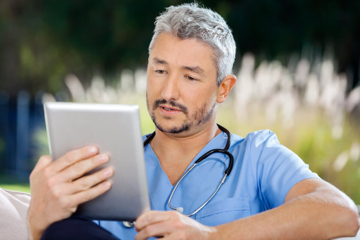 Male nurse with beard outside going through the Florida nursing license renewal process.