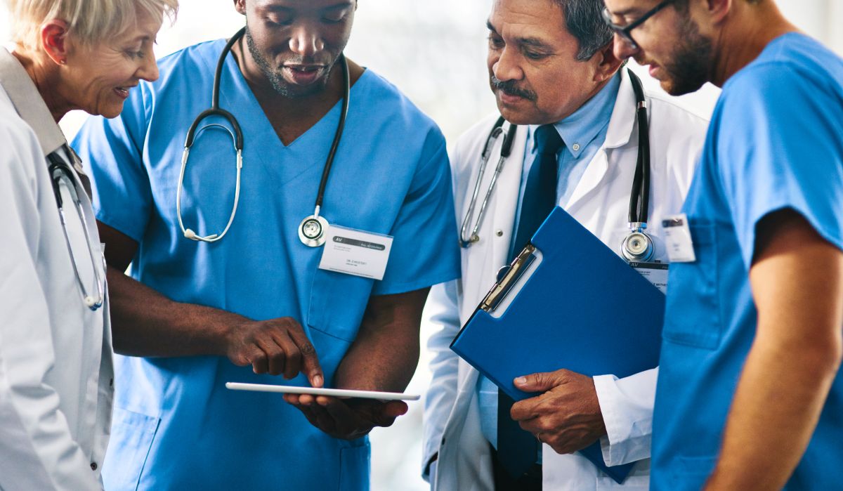 A team of healthcare workers discuss a patient case.