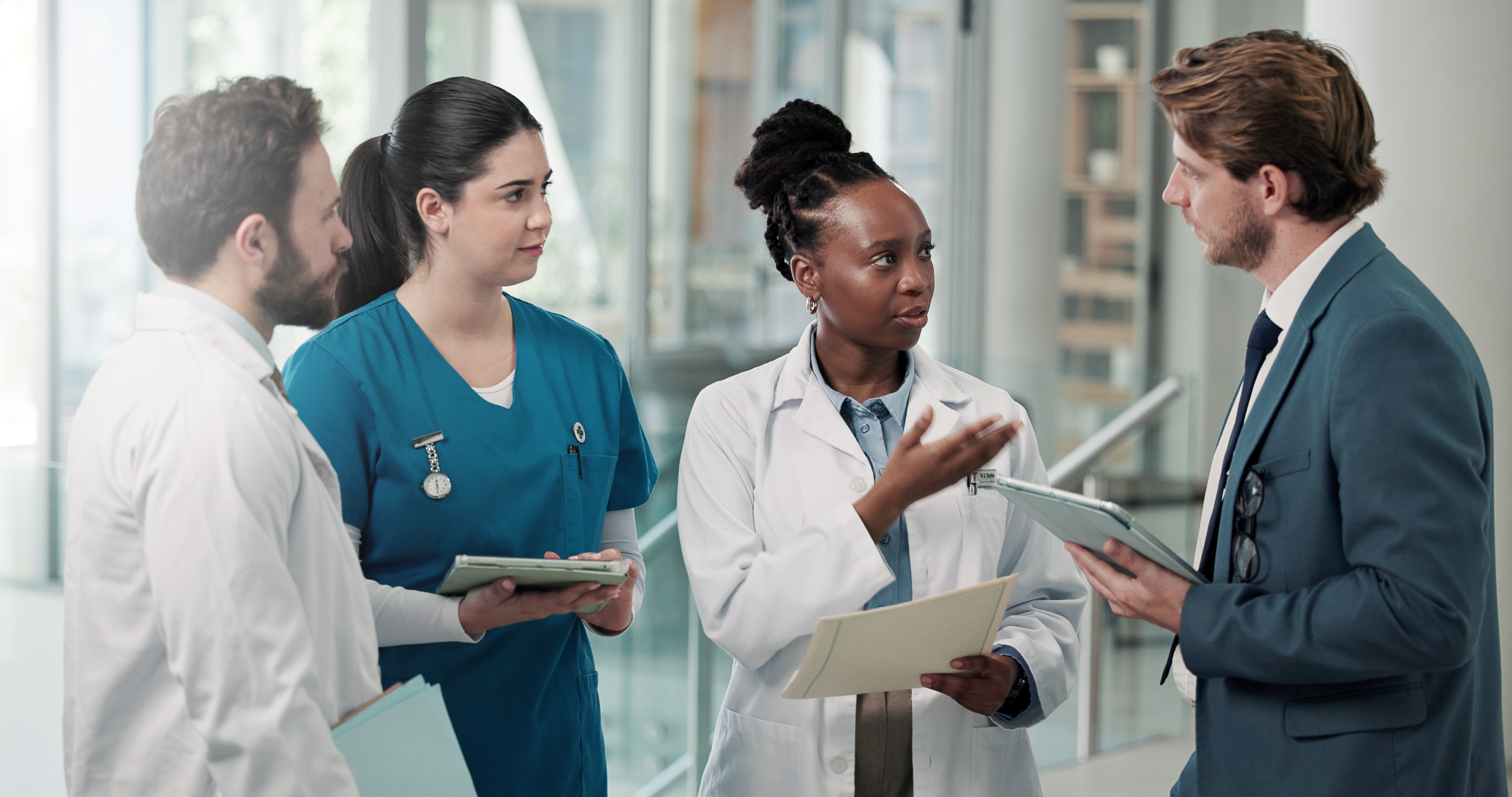 Individuals in a medical setting discussing healthcare policies