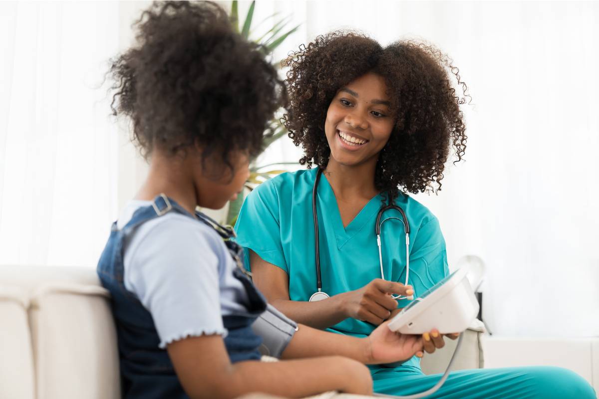 A hematology nurse meets with a young patient.