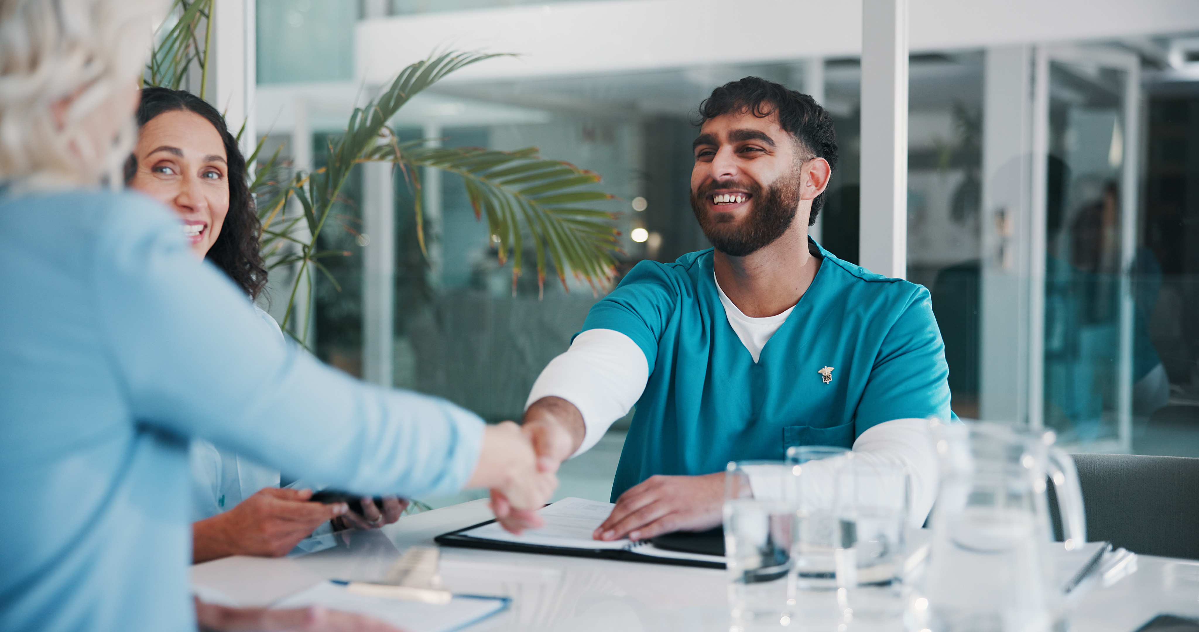 Clinician shaking hands after completing hospital credentialing process for a job