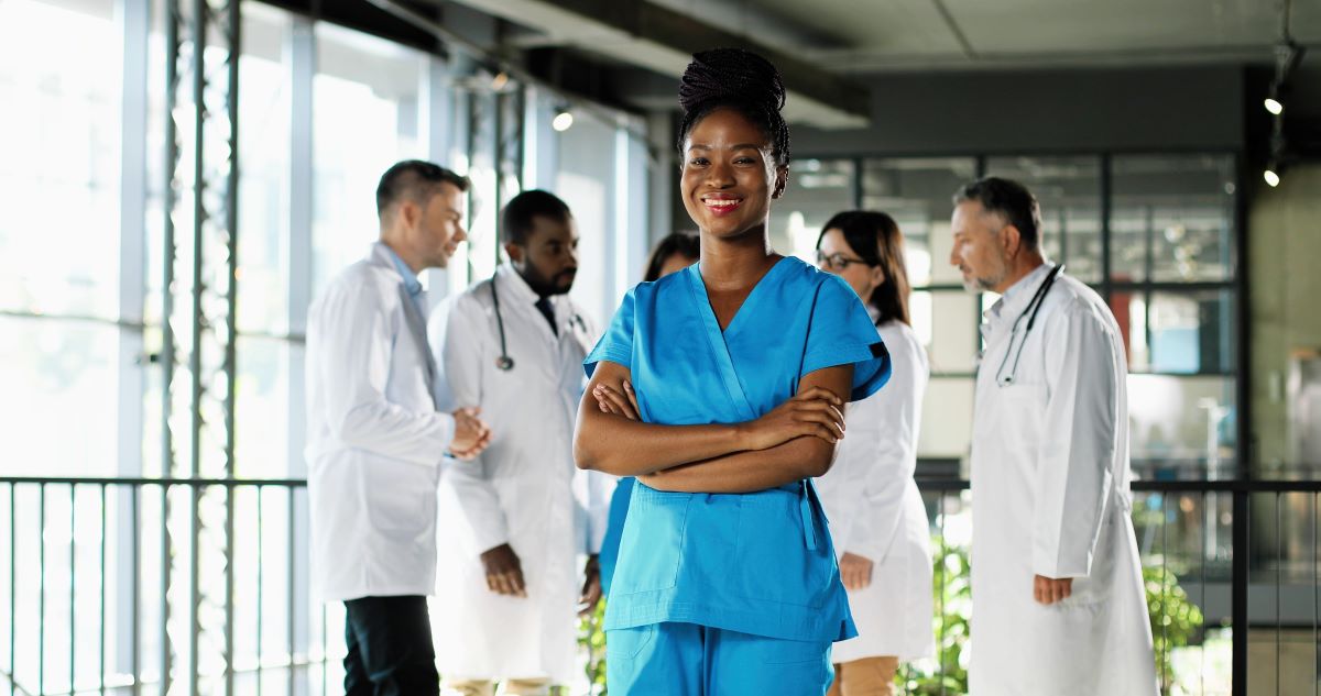 Young African-American nurse in blue scrubs