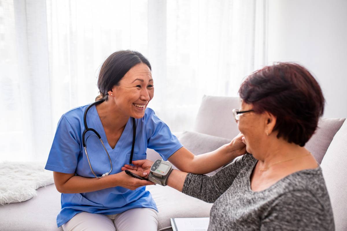 A nurse assists a patient while discussing how to become an RN in North Carolina.