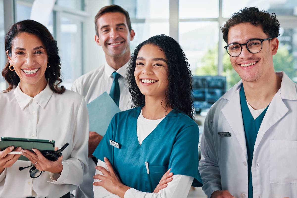 A group of healthcare workers demonstrate interprofessional practice while discussing a patient case.