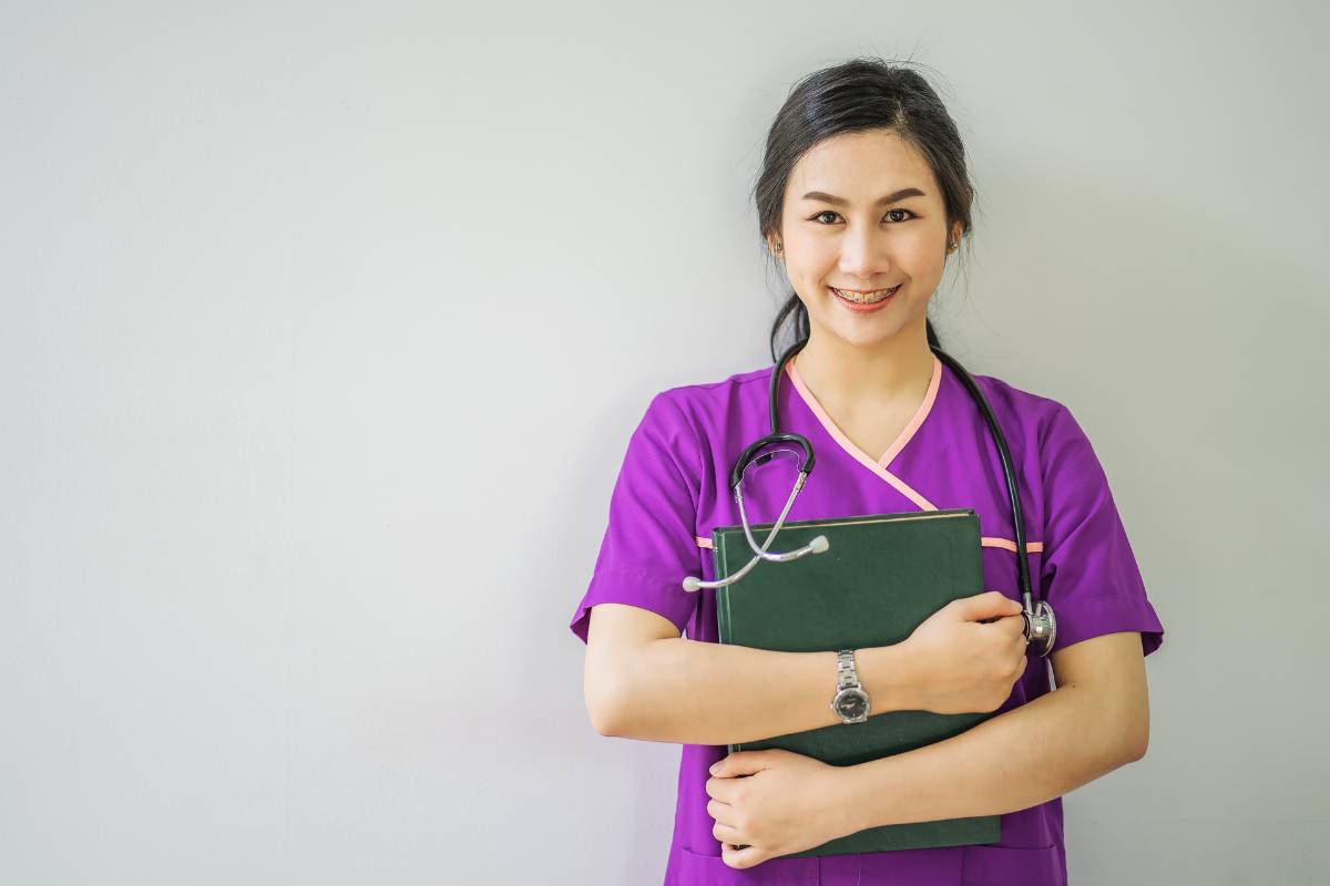 A nurse poses for a photo while discussing how to switch from LPN to RN careers.