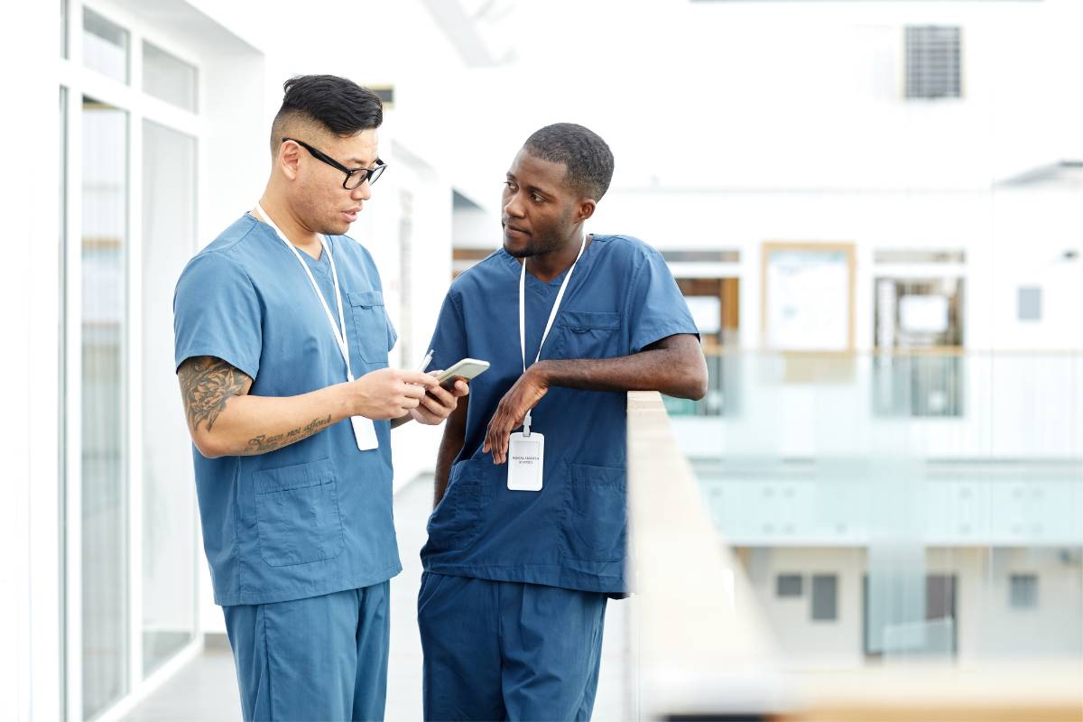 Two men discuss the responsibilities between LPN vs. RN in the hospital.