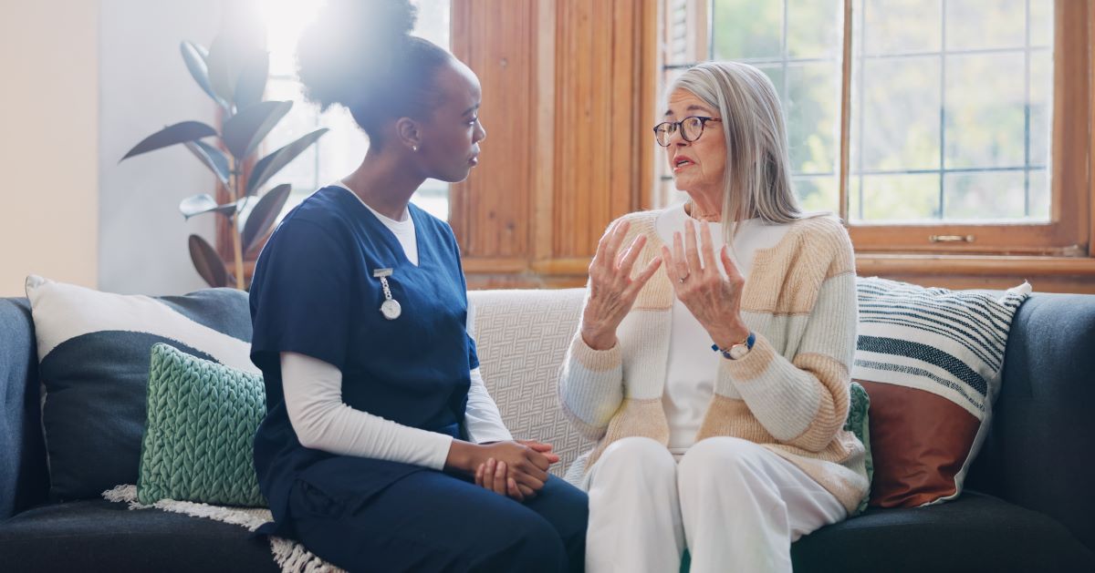A nurse listens to one of her patients explain an event.