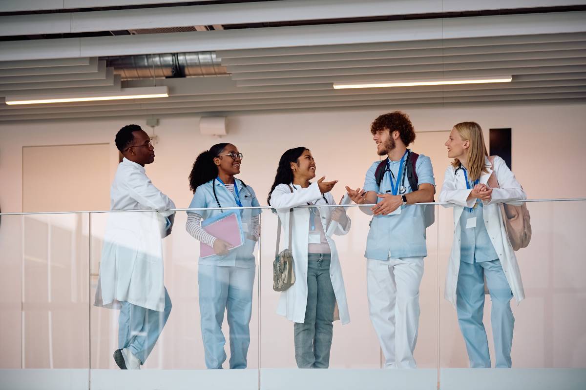 A group of healthcare professionals discusses the Margaret Newman nursing theory after a clinical rotation.