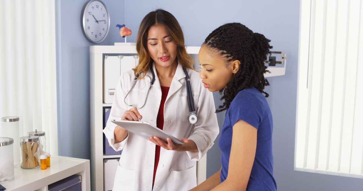 A physician goes over a few things with her patient.