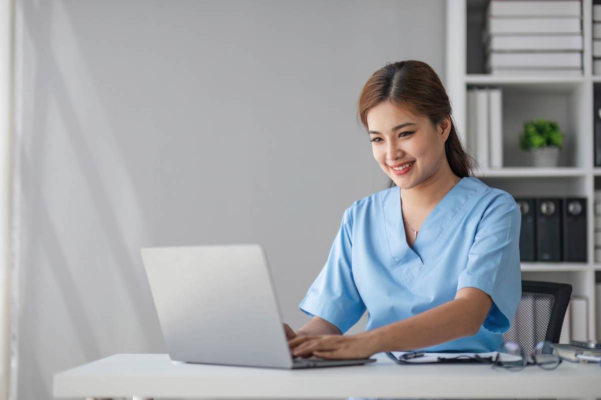 A nurse works on her Michigan nursing license renewal.
