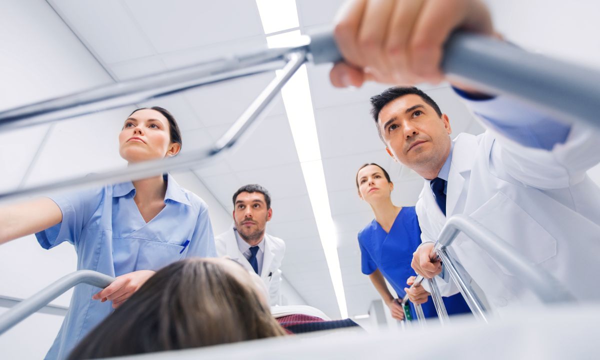 A team of nurses and physicians attends to a patient in a medical emergency.