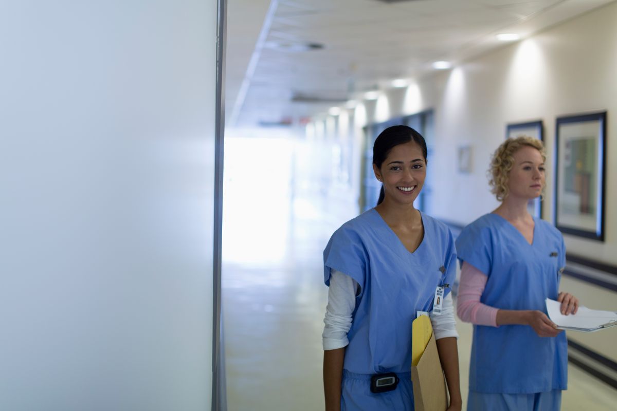 Tow New Hampshire nurses in the hallway of a medical facility.