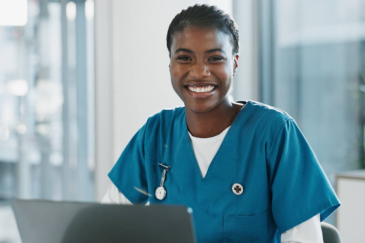 A nurse investigator works on a computer compiling information for an investigation.