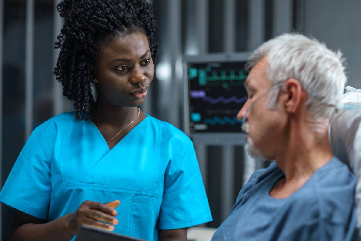 A nurse uses her nurse navigator cover letter skills at work.