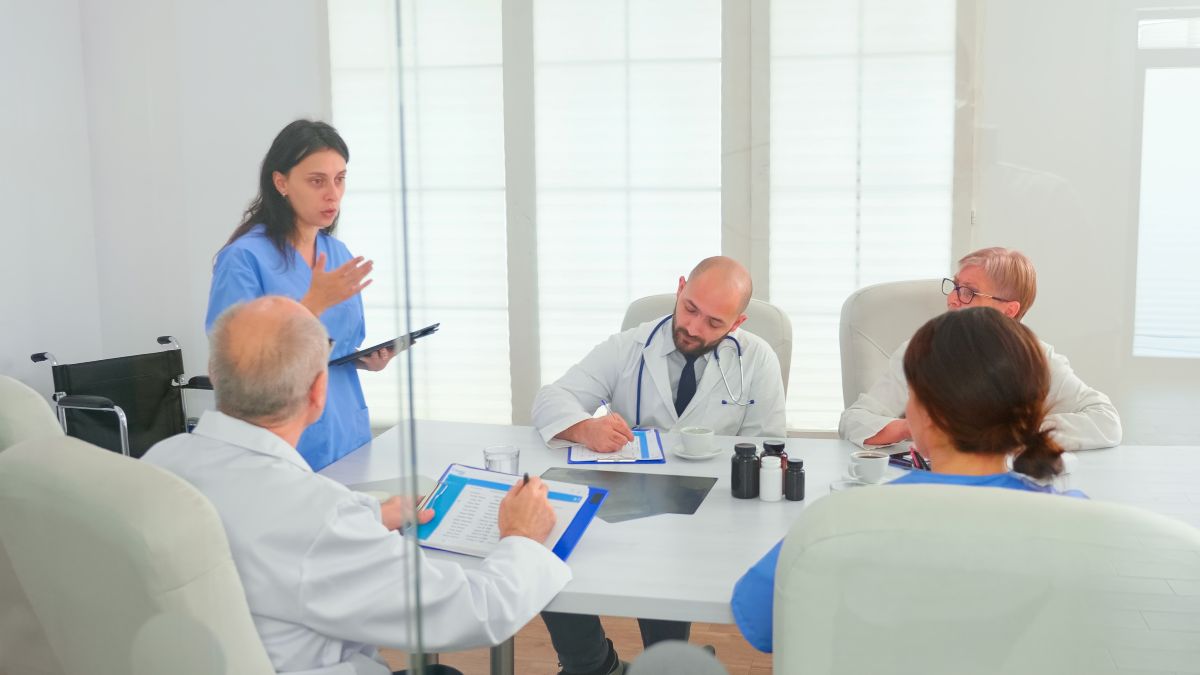 Female clinician making a presentation at a nursing committee meeting