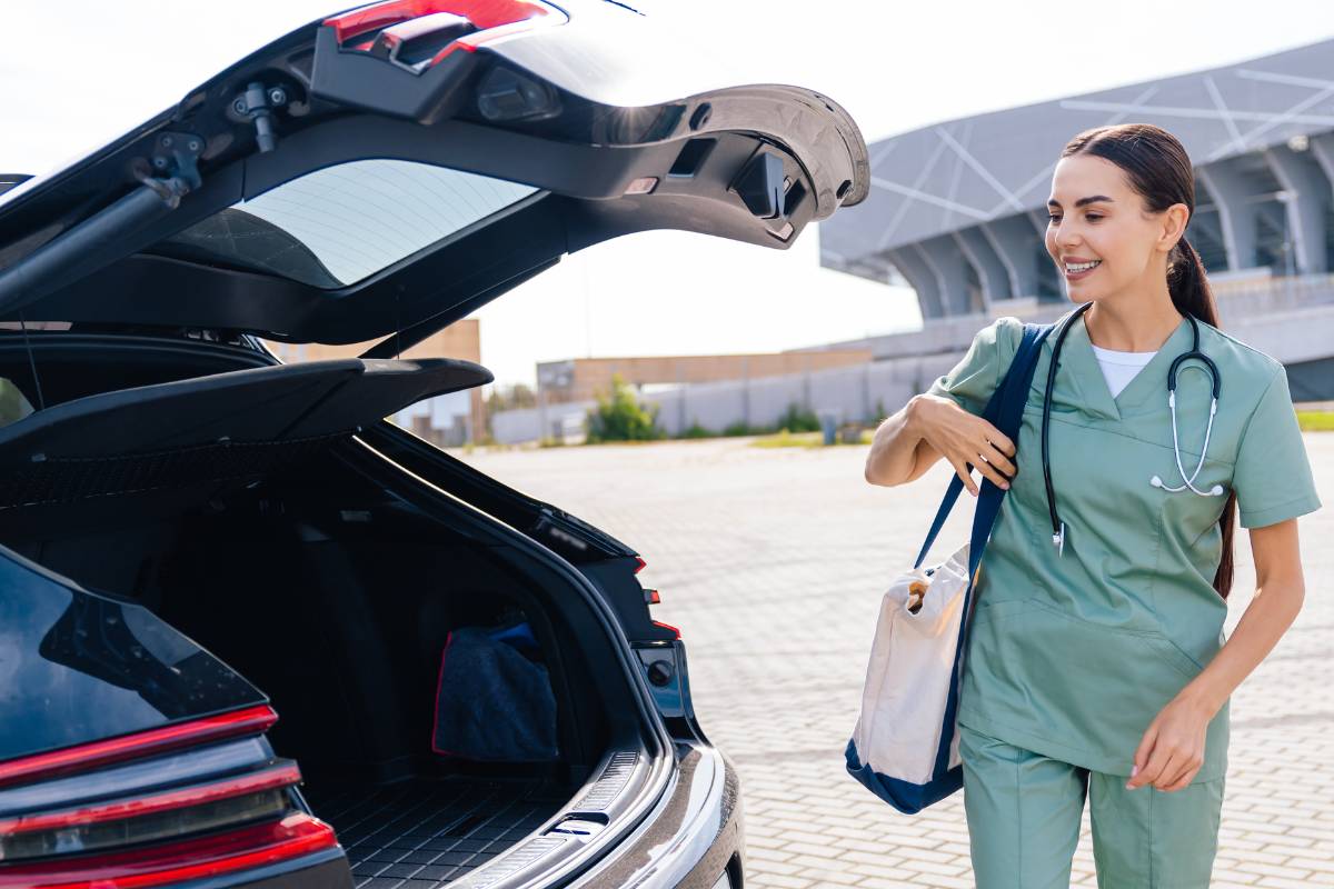 A nursing professional packs their nurse survival kit into their car before work.