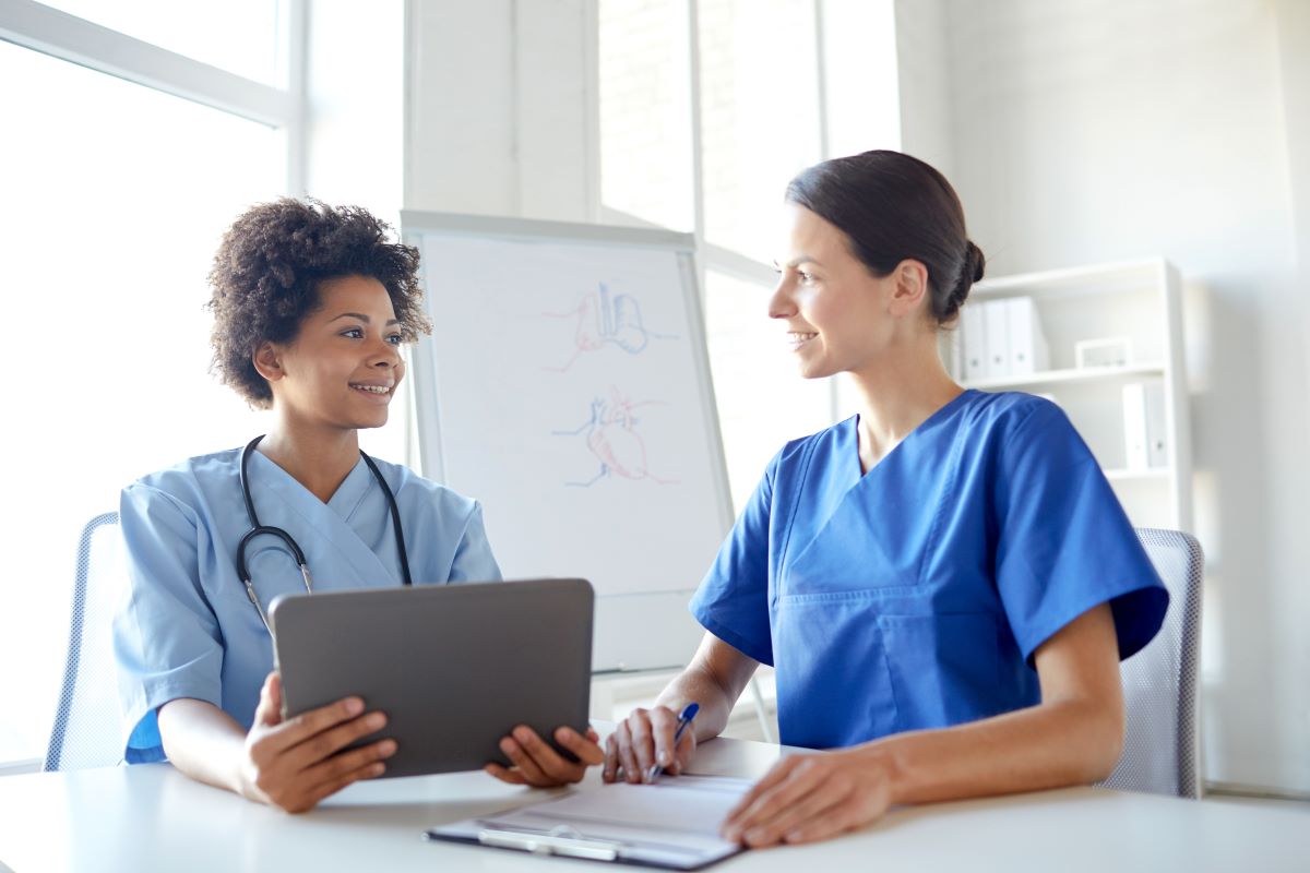 Two nurses talking in a medical office