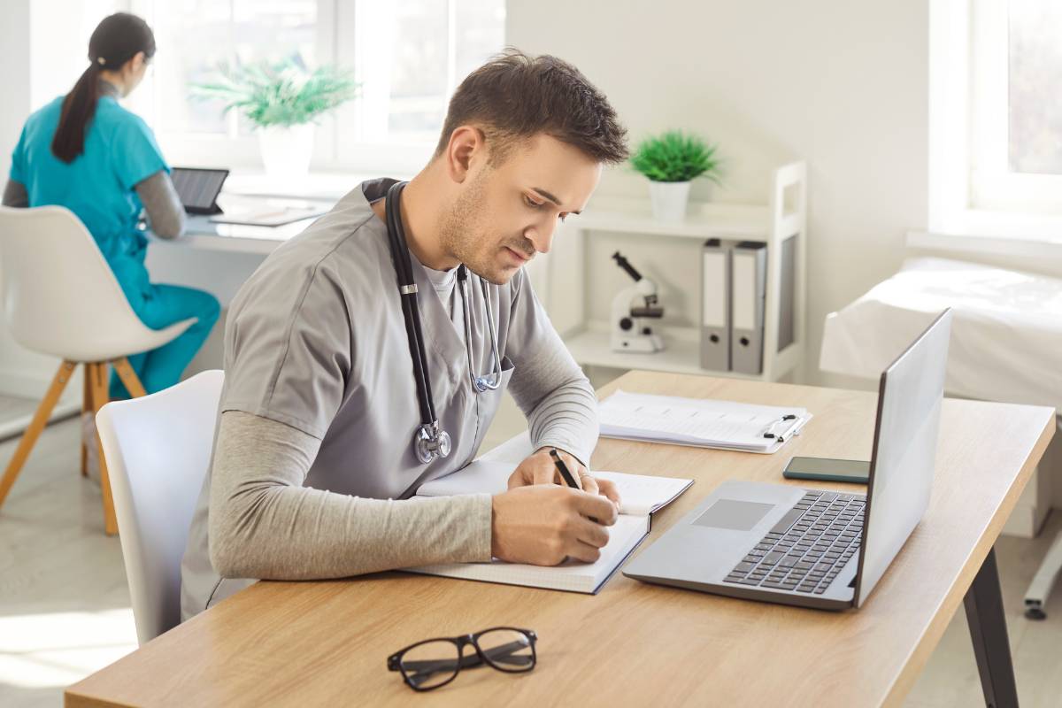 A nurse researches nursing career advancement options on a computer.