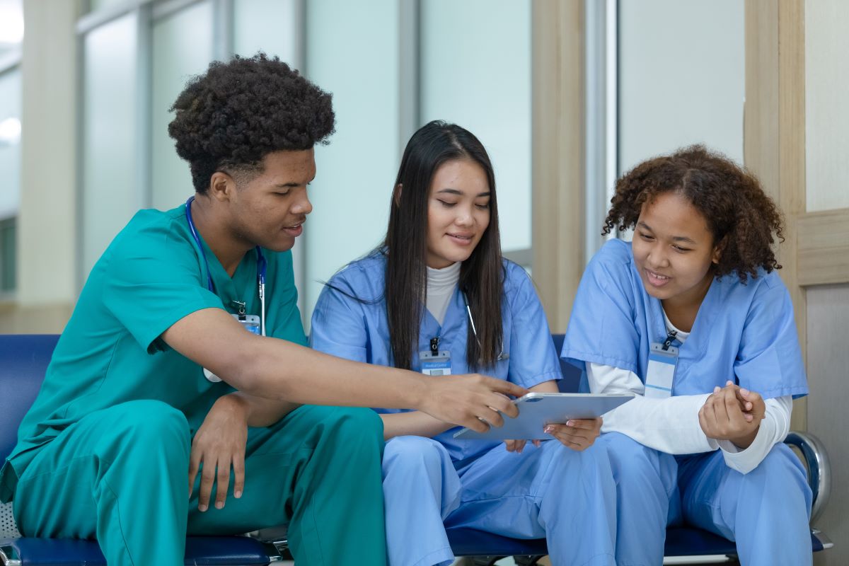 A team of nurses looking at data.