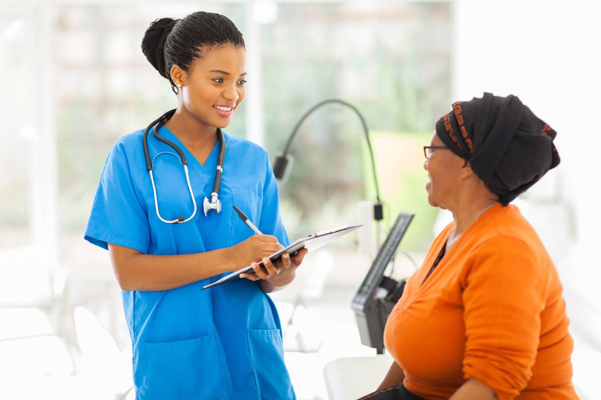 A healthcare professional in blue scrubs enacting the nursing process steps.