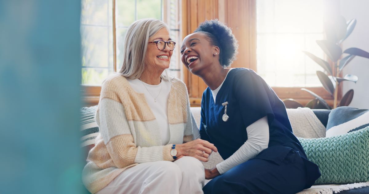 A CNA shares a laugh with an LTC center resident.